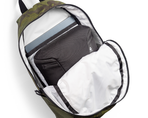 Green backpack with compartments on a white background